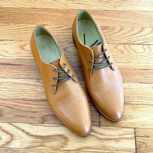 Nisolo oxfords in almond, gently worn.